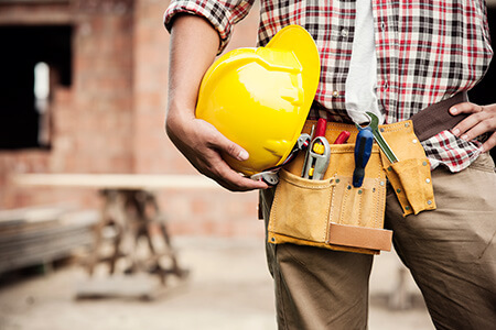 Construction Worker holding helmet
