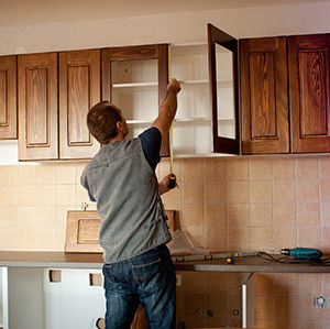 Man working on kitchen cabinets